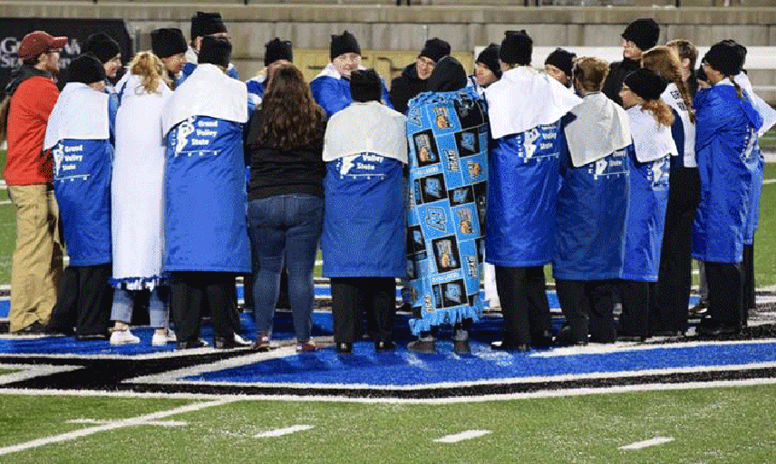 Brothers sing the hymn after football games