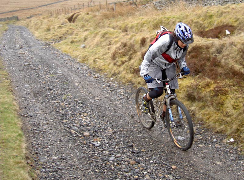 biker climbing up a hill on the bike