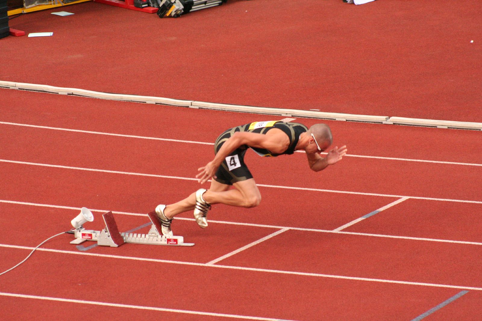 man starting a sprint from starting blocks