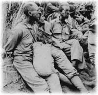 Weary American Soldiers Rest in Utter Fear and Disbelief. -- U.S. Archive Photo